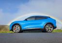 The Ford Mach-E pictured with a rainbow in the background in Kirklees