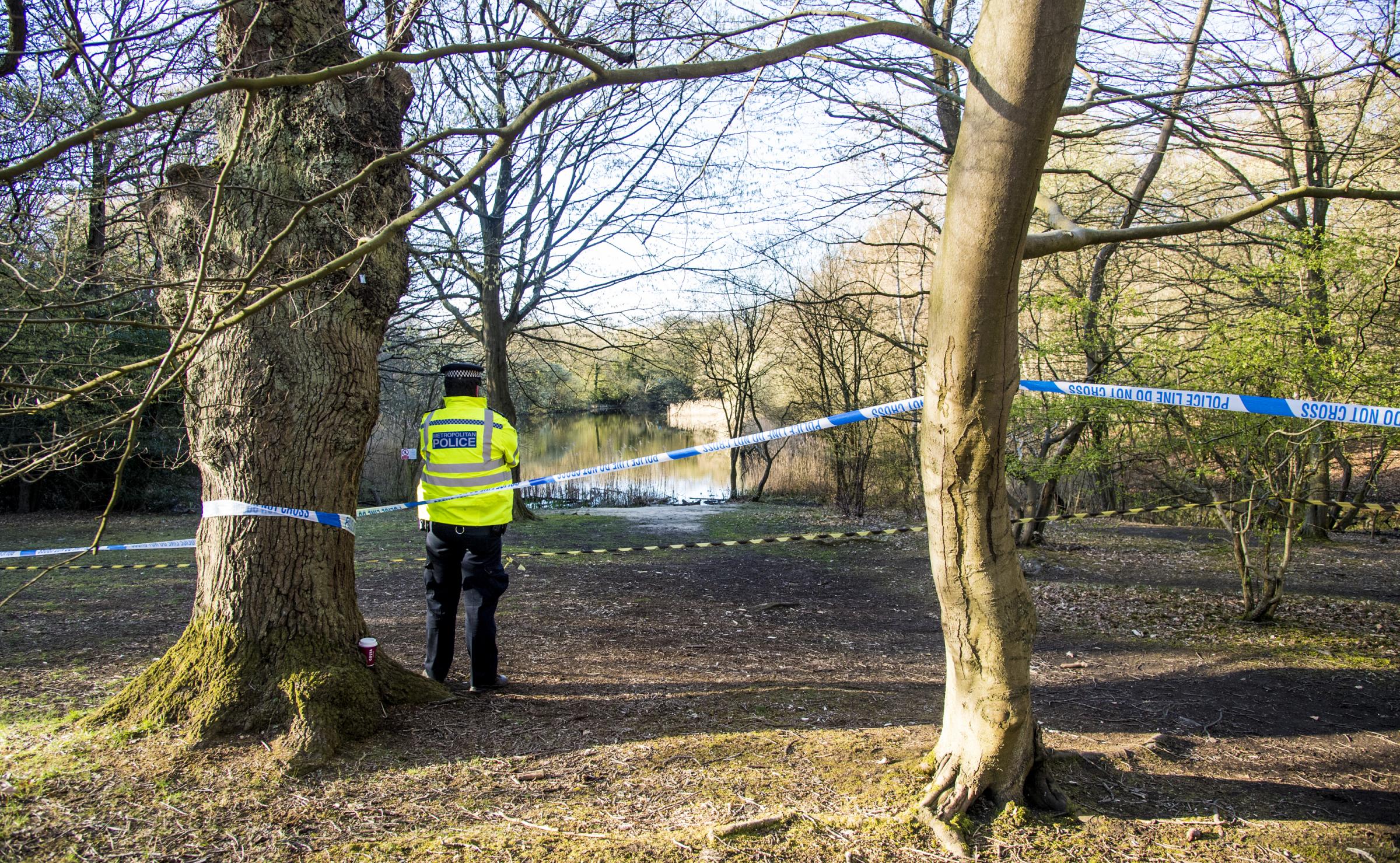 Metropolitan Police officers at the scene at the Wake Valley pond in Epping Forest following the discovery of the body. Photo: PA