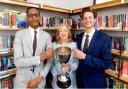 Epping Forest MP Dame Eleanor Laing presents the debating competition cup to Davenant Foundation School students Osaru Ayanru and Martin Prinsloo