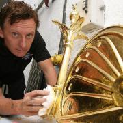 Perry Eales gilding the weathervane at Lopping Hall