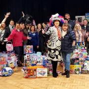 Pearly Queen of Clapton Teresa Watts with 3Food4U volunteers and donations to her toy appeal.