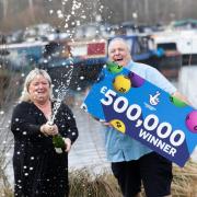 Winners - lottery winning pair from Harlow celebrate lucky numbers with a bottle of champagne