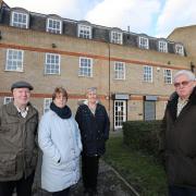 Ron and Margaret Gillett with Myra and Richard Purton outside the Abbey Surgery which is set to close. (EL82220_1)