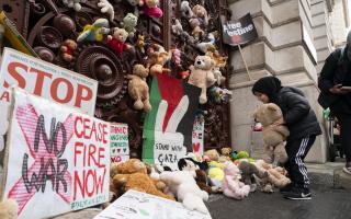 Parents and children lay out cuddly toys across the entrance to the Foreign Office, as they protest to save children's lives in Gaza. Each toy represents a Palestinian child killed during the Israel-Hamas conflict (Image: PA)